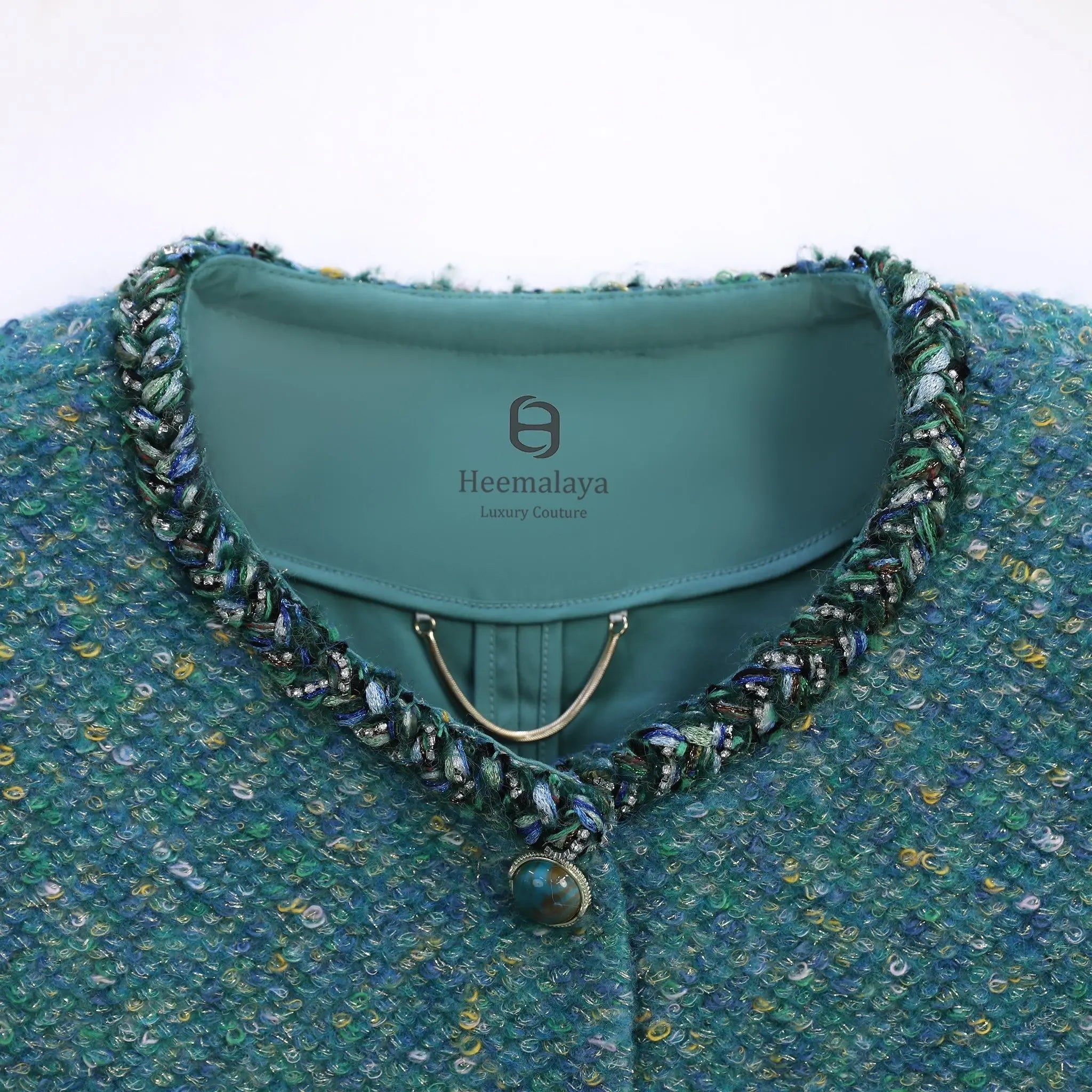 Collar and trim details of green tweed jacket fow women