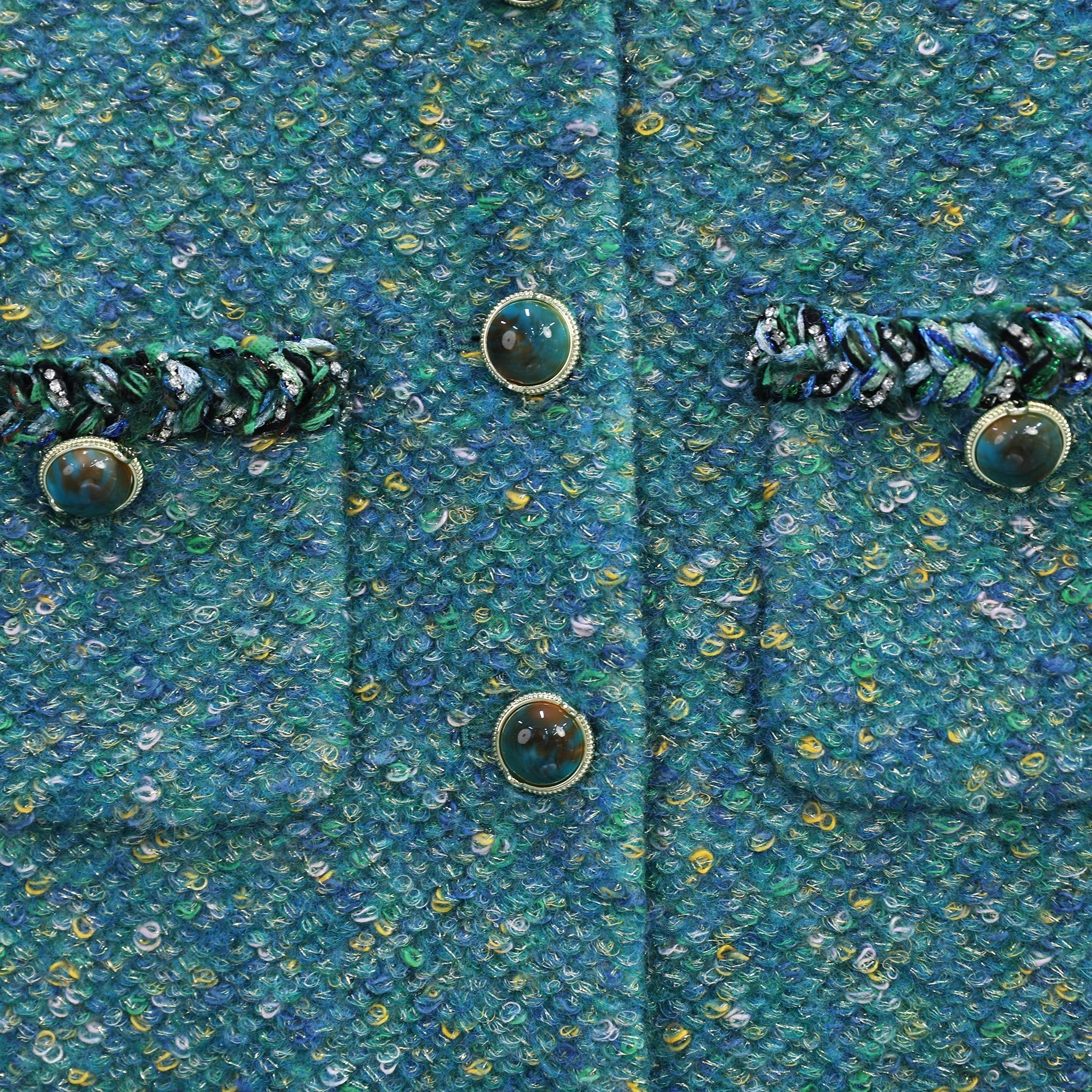 gemstone button details and fabric detials of green tweed jacket