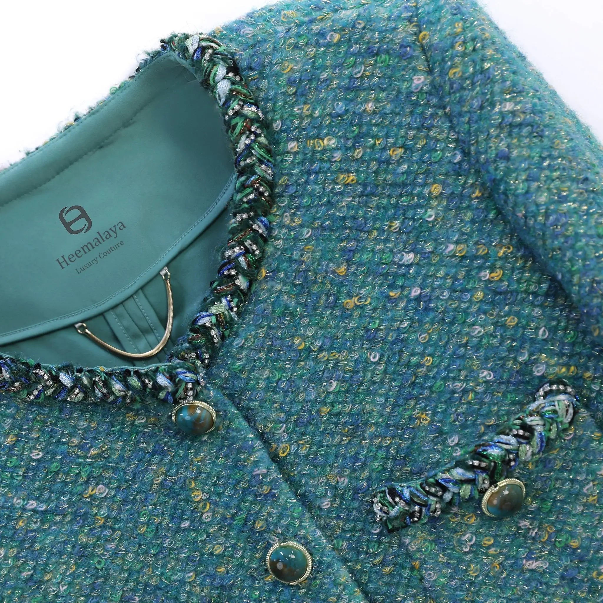 gemstone button details and fabric detials of green tweed jacket